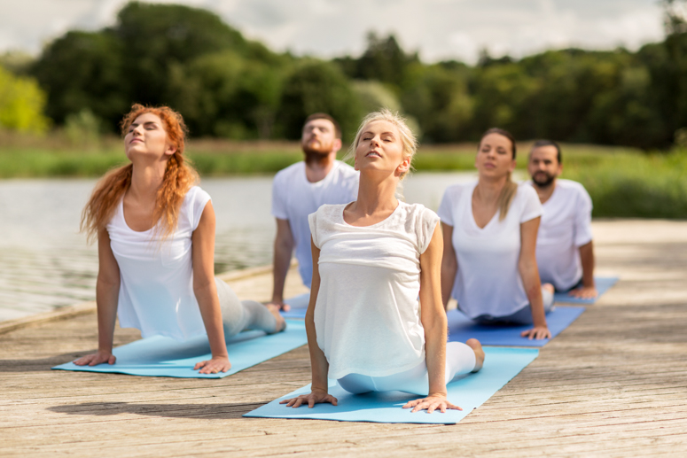 group-of-people-making-yoga-exercises-outdoors-PEUATPE.jpg
